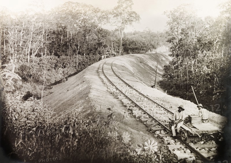 A newly completed section of the Siparia line. Two Trinidad Government Railway workers sit on a hand-operated cart on a newly completed section of the Siparia extension line. Near Siparia, Trinidad, 3 April 1914. Siparia, Trinidad and Tobago, Trinidad and Tobago, Caribbean, North America .