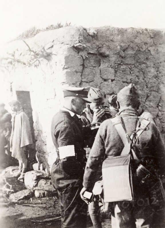 Police and army cooperation' in Samaria. British soldiers and police gather outside a village dwelling during operations in the region of Samaria. During the period of the Great Uprising (1936-39), an additional 20,000 British troops were deployed to Palestine in an attempt to clamp down on Arab dissidence. Tilfit, British Mandate of Palestine (West Bank, Middle East), 1938., West Bank, West Bank (Palestine), Middle East, Asia.