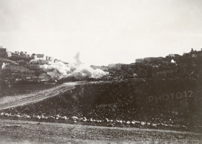 Demolition of a Palestinian house. A cloud of dust engulfs a residential area in Nablus following the demolition of a Palestinian house, a measure taken by British forces to clamp down on Arab dissidence during the Great Uprising (1936-39). Nablus, British Mandate of Palestine (West Bank, Middle East), circa 1938. Nablus, West Bank, West Bank (Palestine), Middle East, Asia.