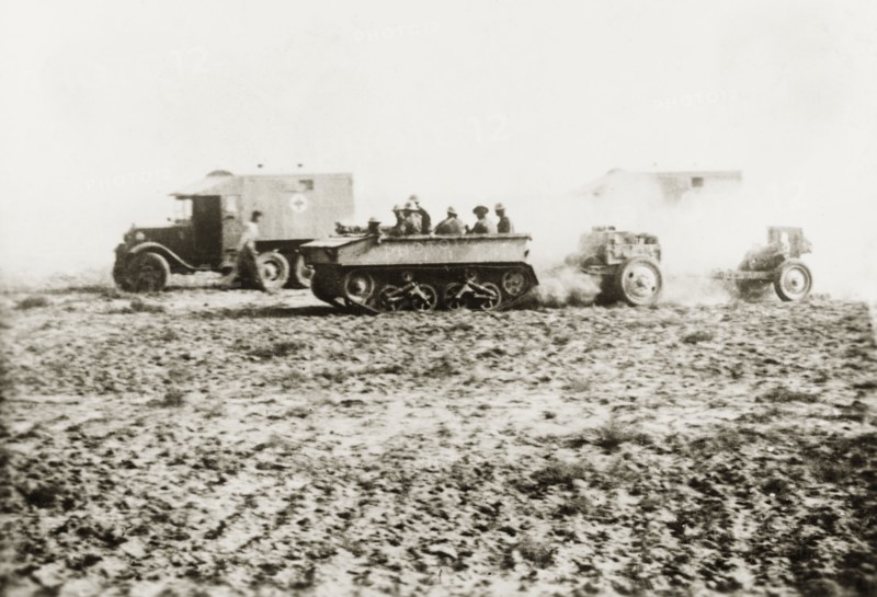 British medical trucks and tanks in Palestine. Ambulance trucks of the Royal Army Medical Corps and an armoured tank cross an open patch of ground in the Palestinian countryside. During the period of the Great Uprising (1936-39), an additional 20,000 British troops were deployed to Palestine in an attempt to clamp down on Arab dissidence. British Mandate of Palestine (Middle East), circa 1938., Middle East, Asia.