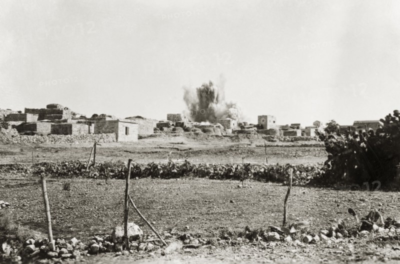 Demolition of a Palestinian house. An explosion rips through a Palestinian village as a house is blown up by the Royal Engineers. Targeting such rebel dwellings was a measure taken by British forces to clamp down on Arab dissidence during the Great Uprising (1936-39). British Mandate of Palestine (Middle East), circa 1938., Middle East, Asia.