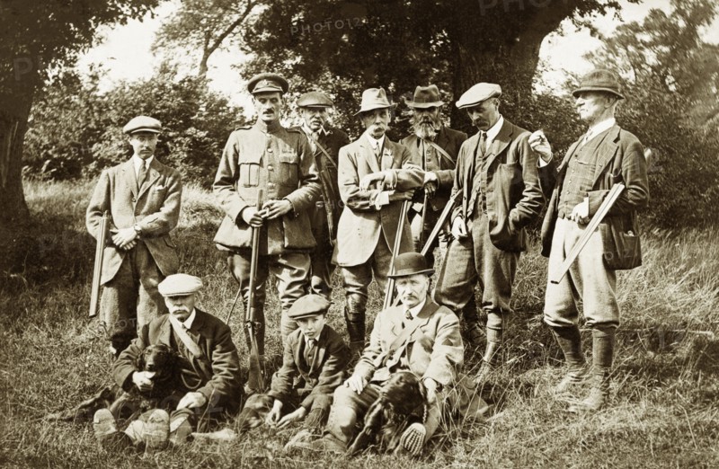 Shooting party at Hardwick Estate. A group of men and a young boy pose for a portrait with rifles and gun dogs whilst hunting at Hardwick Estate. Derbyshire, England, circa 1918., Derbyshire, England (United Kingdom), Western Europe, Europe .