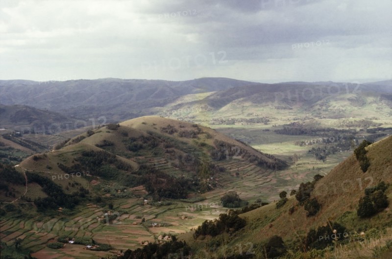 A valley in Ankole. View looking north-east across a valley in Ankole. Terraced shambas can be seen on a hillside in the foreground. Soko, West Uganda, 1963., West (Uganda), Uganda, Eastern Africa, Africa.