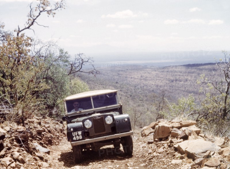 Climbing Mount Moroto by Land Rover. A Land Rover climbs the rocky Ilipath Peak on Mount Moroto in Karamoja. A related caption identifies the driver as Bill Clarence. North East Uganda, December 1960., East (Uganda), Uganda, Eastern Africa, Africa.