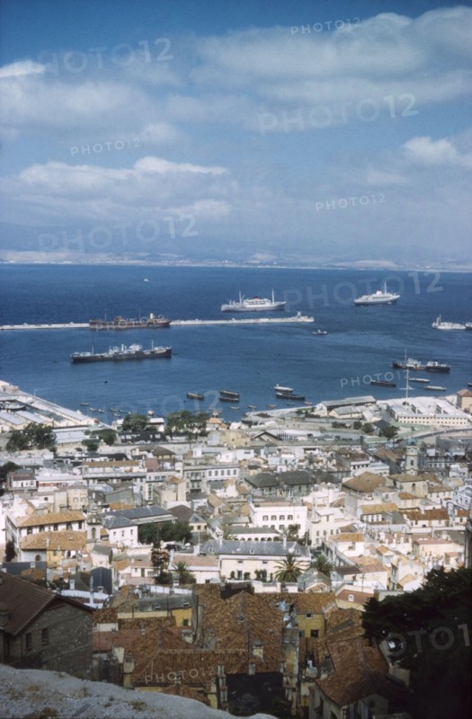 A view over Gibraltar town and harbour. View from high ground across the city and harbour of Gibraltar, "the first port of call for all ships bound for the Indian Ocean". Gibraltar, July 1958. Gibraltar, Gibraltar, Gibraltar, Mediterranean, Europe .