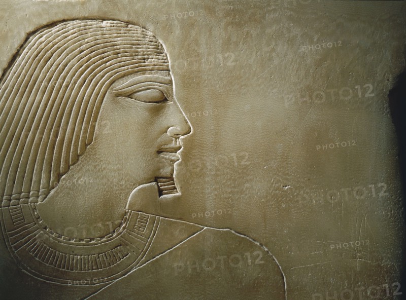 An alabaster panel decorated in sunk relief with a profile head and torso of Rawer