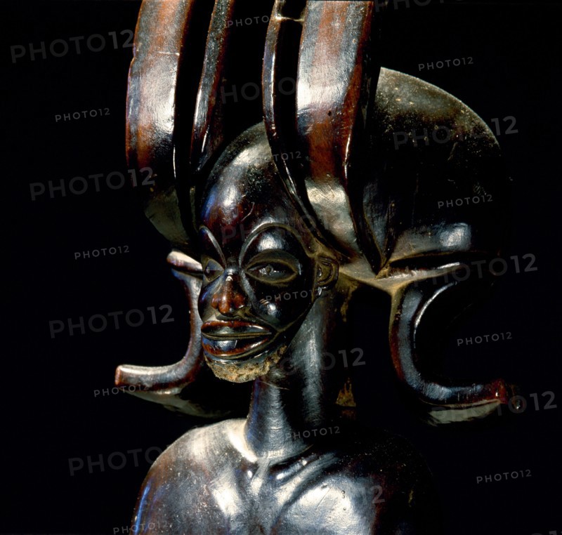 Wood figure of wearing headdress that is characteristic of Chokwe chiefs and also found on important masks
