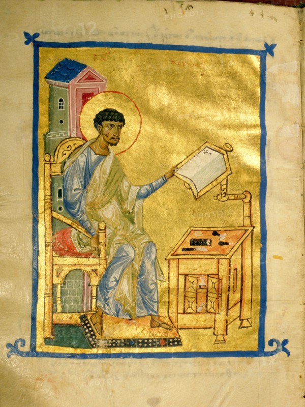 An illumination from a manuscript depicting St Luke at his desk on which there appears to be a set of engravers tools