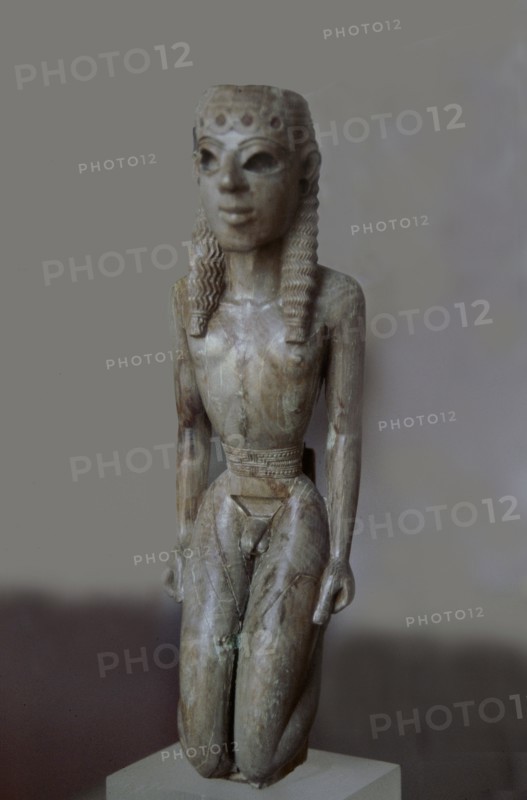 Ivory figurine of a kneeling youth used as a lyre support