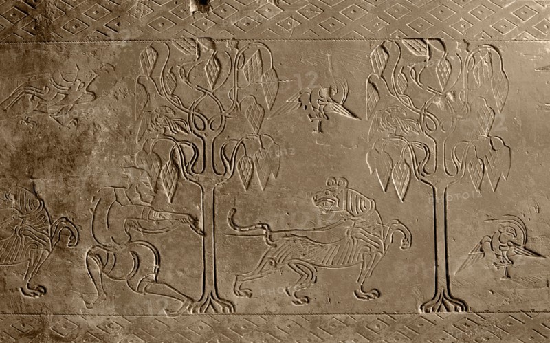 Brick from a tomb structure impressed with design of a man, tree, birds and a tiger