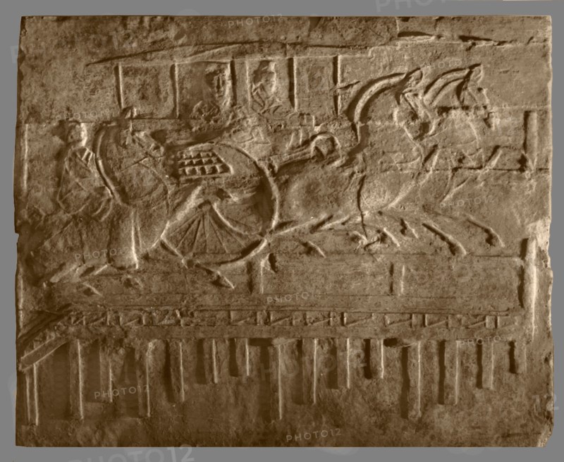 Brick from a tomb structure impressed with horses and carriage crossing a bridge