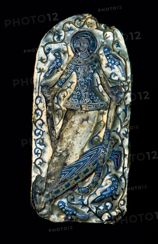 A gold and enamel plaque with a figure of a dancing girl
