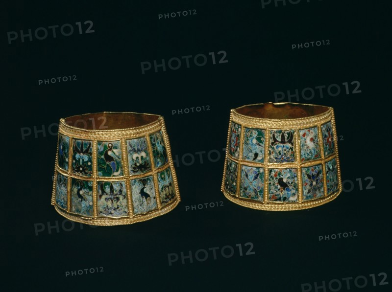 Arm bands made from two hinged pieces of gold with coloured cloisonne enamels set in panels all round