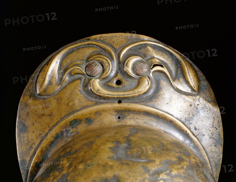 Detail of the peak of a bronze helmet