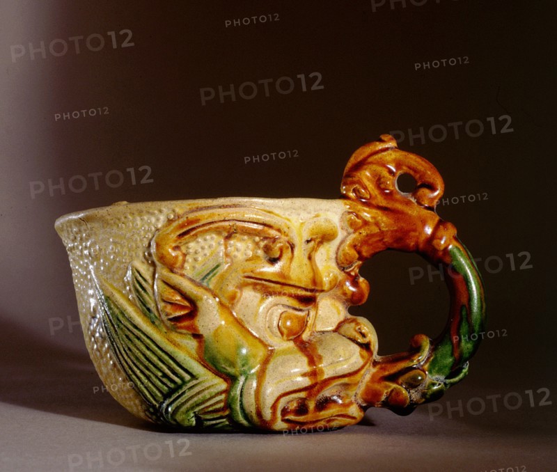 Rhyton cup with handle in the form of a lotus which emerges from the mouth of a symbolic monster mask or tao tieh