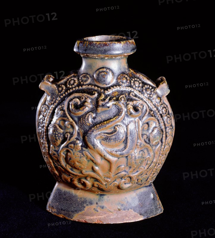 A molded brown glazed flask decorated on one side with a phoenix