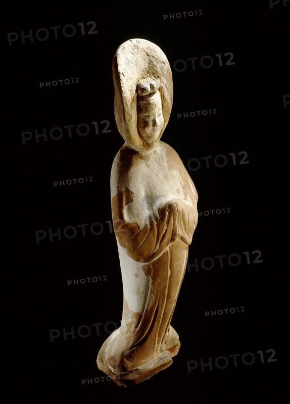 A painted earthenware figure of a lady wearing a voluminous hooded cloak