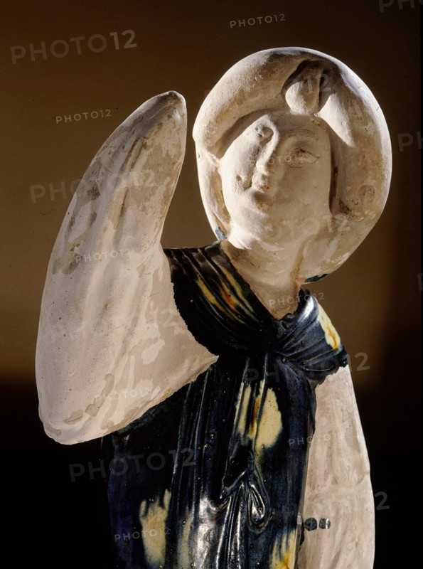 Blue glazed figure of a court lady with one arm raised
