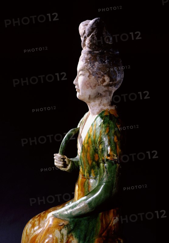 Figure of a seated court lady holding a lotus stem