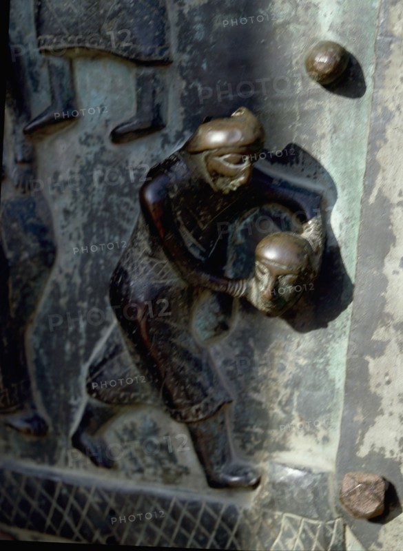 Detail of the bronze door of the Basilica of San Zeno which is decorated with 48 panels illustrating biblical stories and the lives of St Peter, St Paul, St Zeno, St Helena among others, and items connected with music and the three Theological Virtues