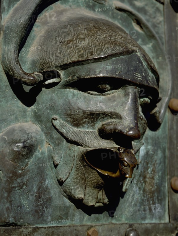 Detail of the bronze door of the Basilica of San Zeno which is decorated with 48 panels illustrating biblical stories and the lives of St Peter, St Paul, St Zeno, St Helena among others, and items connected with music and the three Theological Virtues