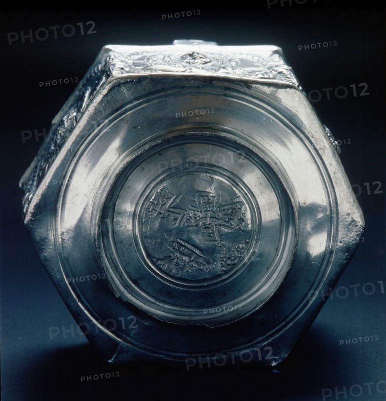 The base of a six sided silver vessel which is marked by a control stamp