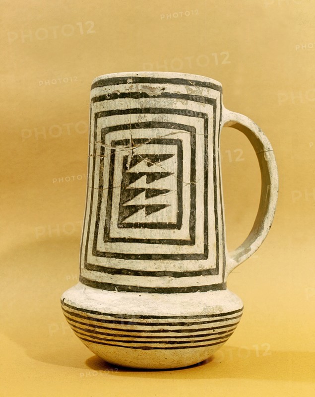 A black on white pitcher