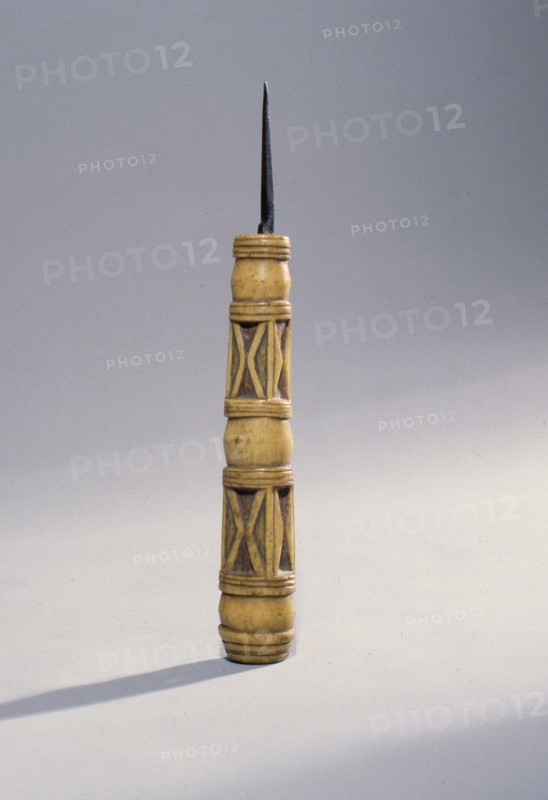 Sewing awl with a carved bone handle