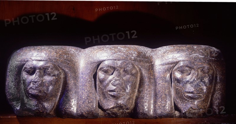 A base of a royal statue which shows the heads of prostrate captives