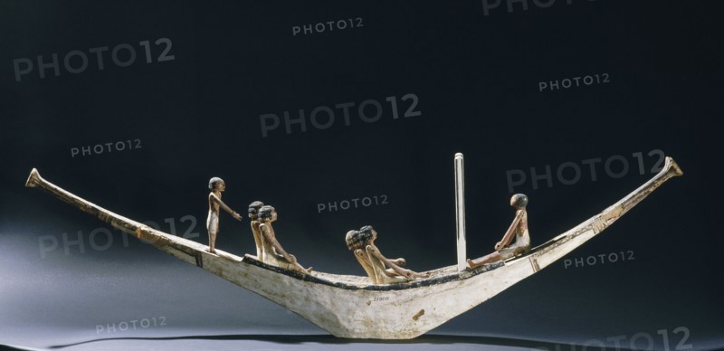 A model of a rowing boat with crew and two steering posts