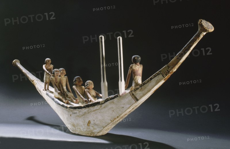 A model of a rowing boat with crew and two steering posts