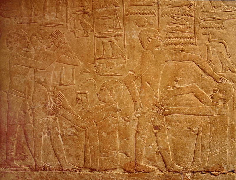 A detail of a relief in the tomb of Ankhmahor at Saqqara depicting a priest performing ritual circumcision on a young boy