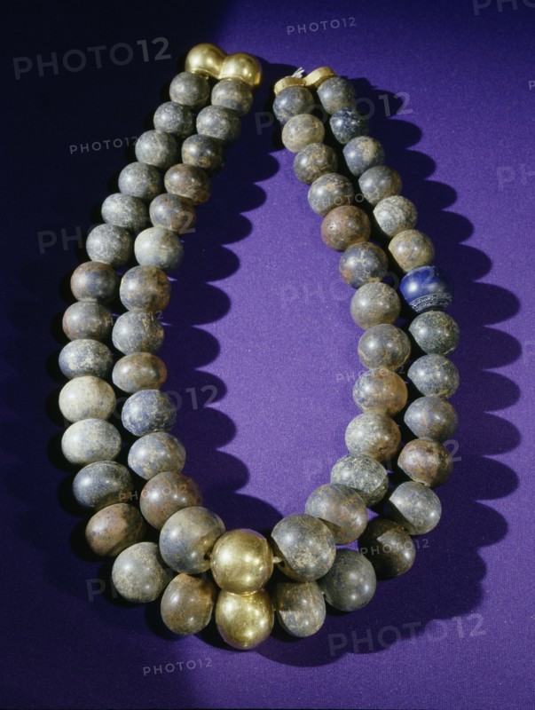 Necklace of double strands of lapis lazuli beads, with gold clasp and two gold beads at centre