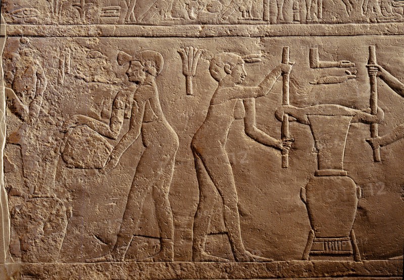 Bas relief from the tomb of Pairkep showing servant women squeezing oil from lilies in a press for use in perfume