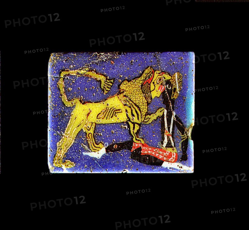 Glass plaque depicting a lion, representing the pharaoh, devouring a Nubian prisoner