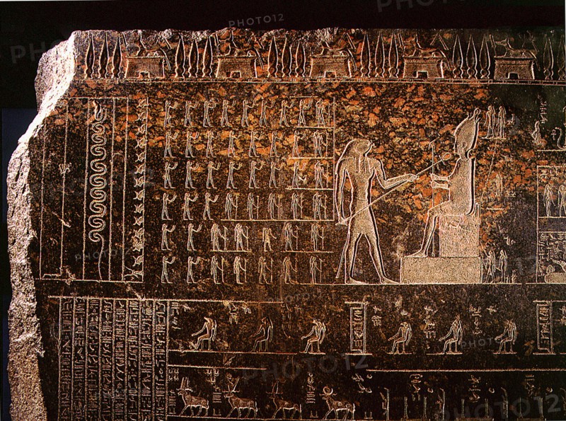 Detail from a sarcophagus depicting Horus reviving with the ankh, sign of life, his father Osiris, while standing deities raise their hands in adoration