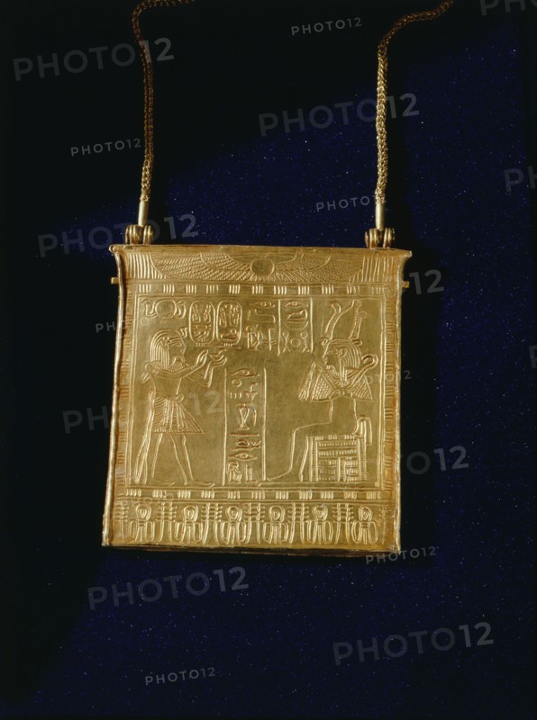 Gold pectoral on chain, from the tomb of Amenemope, showing the king offering incense to the enthroned Osiris
