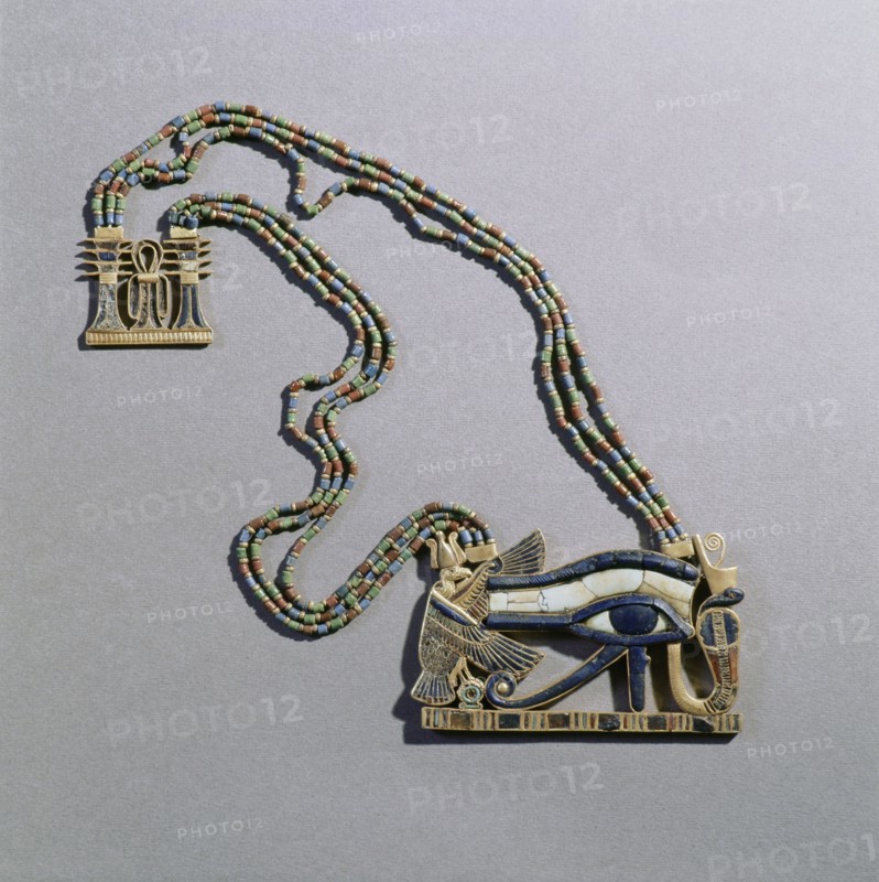 A pendant from the tomb of Tutankhamun in the form of a Wedjat eye, symbol of protection, flanked by the vulture goddess, Nekhbet and the snake goddess Wadjet, protectors of Upper & Lower Egypt