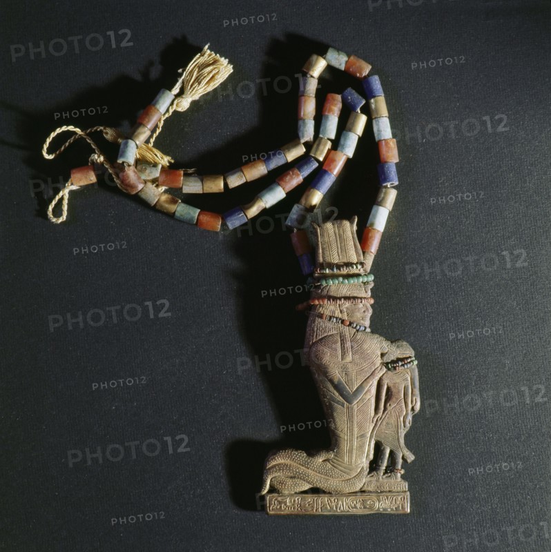 A pendant of gold attached to a string of beads