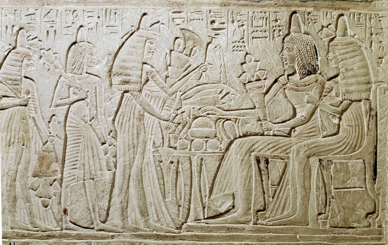 Stela relief with a couple seated before a table of food