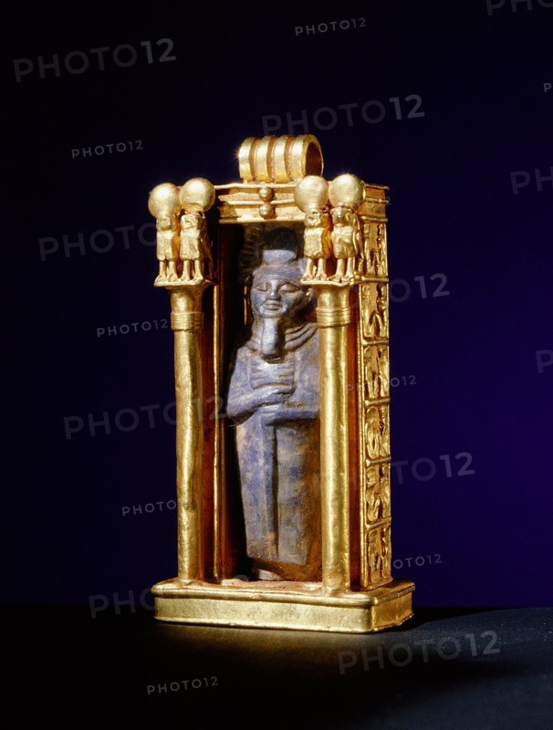 Damaged lapis lazuli amulet of the god Ptah, re used within a gold shrine, from the tomb of Wen Djeba En Djed, senior official of Psusennes I