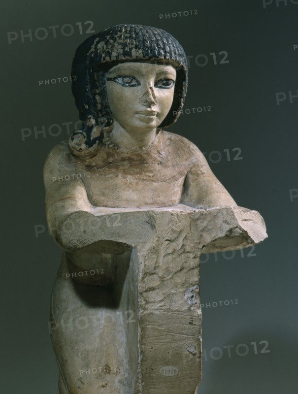 Painted stone figure of a kneeling woman, from an offering scene