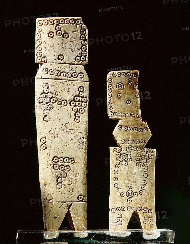 Two Coptic bone dolls of schematic flat peg form with incised circle decoration