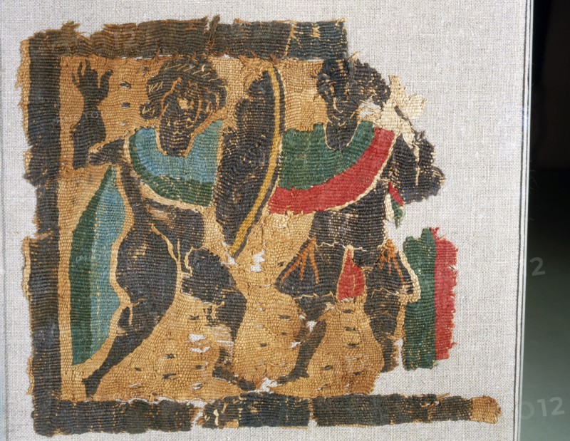 Textile with design of warriors fighting