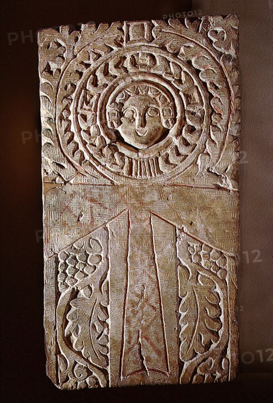 Early Christian stela incorporating a looped cross (crux ansata) or ankh symbol, surrounded by the vine of eternal life, illustrating the fusion of pharaonic iconography with Christian motifs in Byzantine Egypt