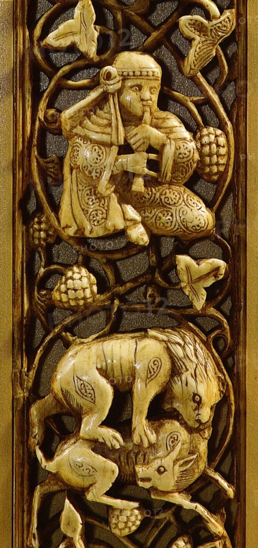A detail of an ivory inlay from a piece of furniture depicting a lion attacking a deer