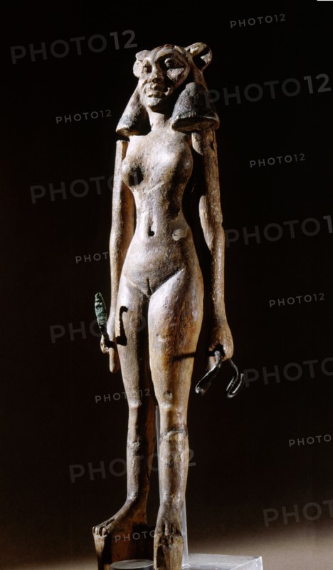 Figurine of a nude female dancer wearing a leonine mask, holding a bronze serpent in each hand