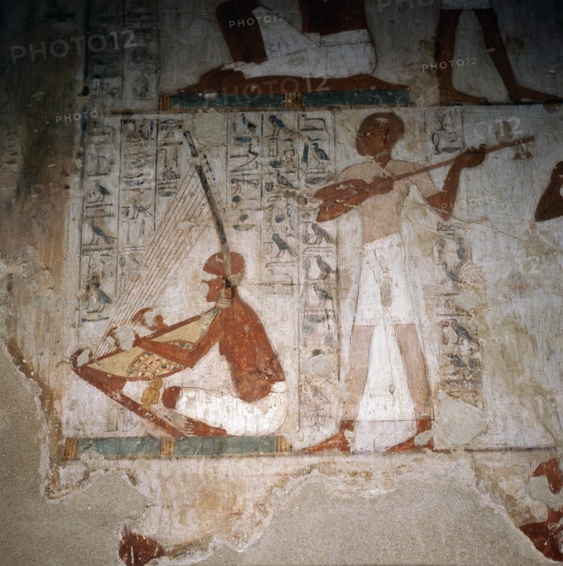 A detail of a wall painting in the tomb of Rekhmire showing musicians playing the harp and the lute