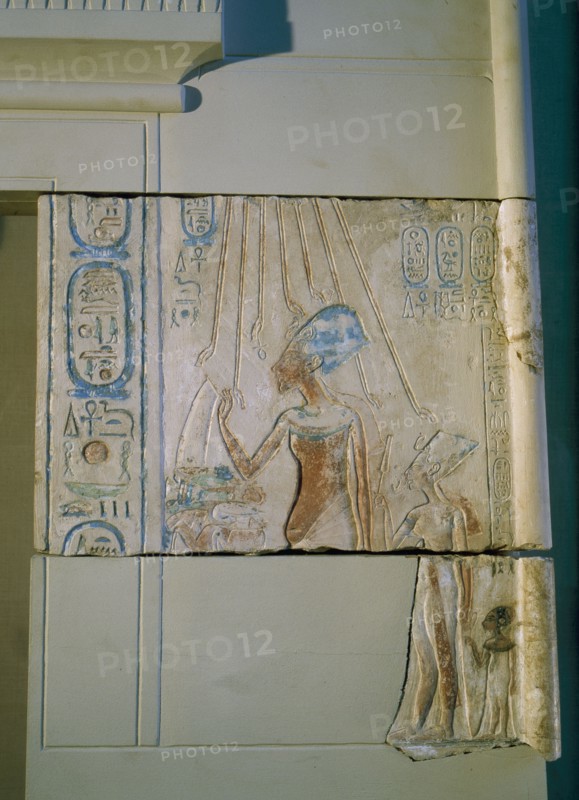 Sunk relief from the facade of a shrine showing Akhenaten and Nefertiti offering libations to Aten, the sun god
