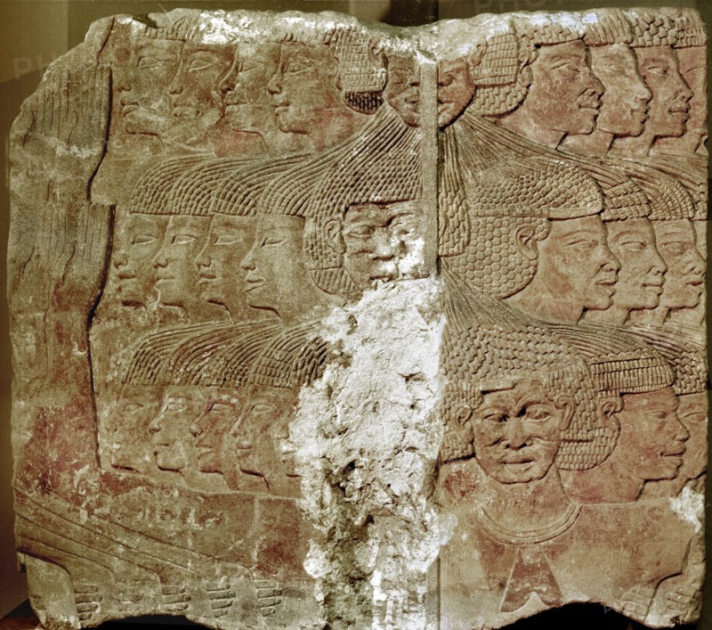 Fragment of a painted relief depicting a group of captive Sea People, tied together by the hair